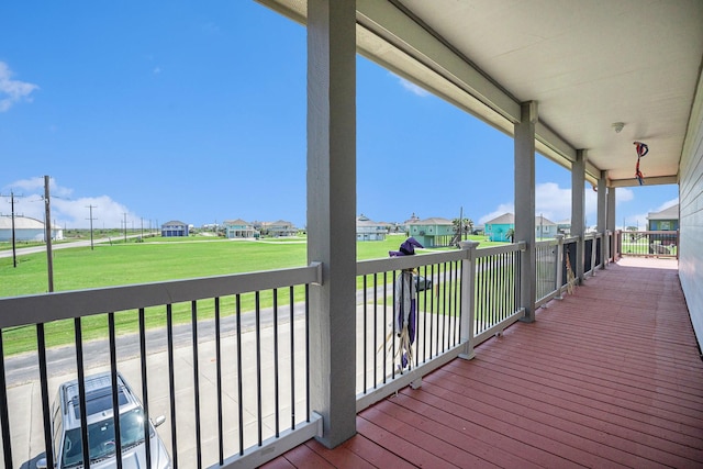 wooden terrace with a yard and a residential view