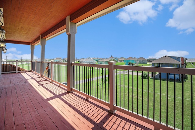 wooden deck featuring a yard and a residential view