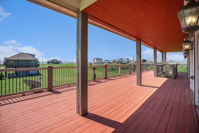 deck featuring a lawn and a residential view