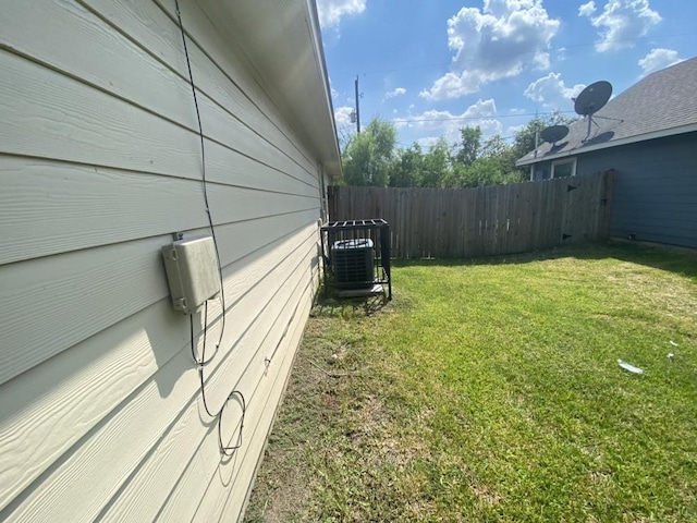 8046 Parker Rd, Houston, TX 77078 - view of side of home with a lawn, central AC unit, and fence
