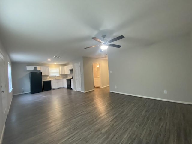8046 Parker Rd, Houston, TX 77078 - unfurnished living room with dark wood finished floors, baseboards, and a ceiling fan