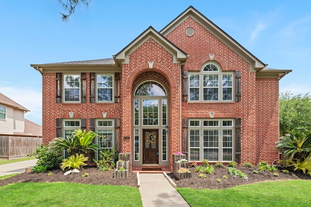 view of front of property with a front lawn and brick siding