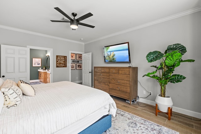 bedroom featuring baseboards, ornamental molding, connected bathroom, and wood finished floors