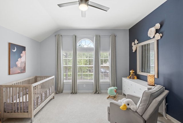 bedroom featuring carpet flooring, a ceiling fan, baseboards, a crib, and lofted ceiling