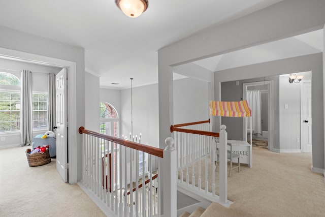 hallway featuring an upstairs landing, carpet, a notable chandelier, and baseboards