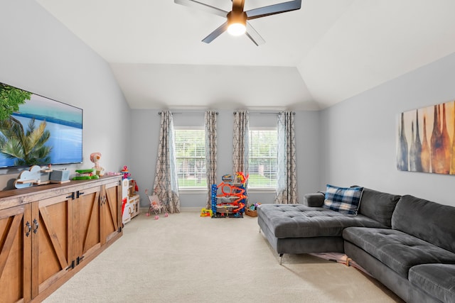 living room featuring carpet, a ceiling fan, and lofted ceiling