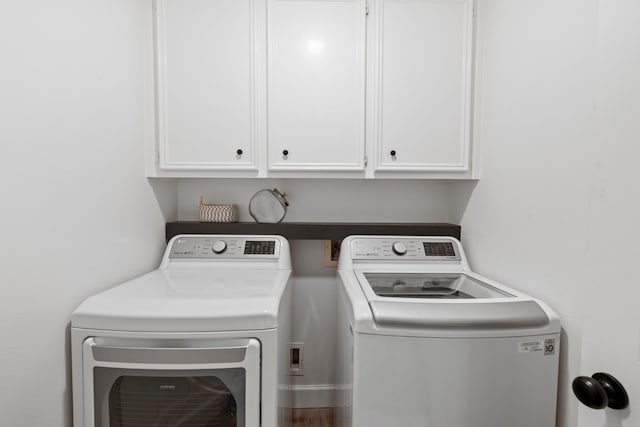 laundry area with cabinet space and separate washer and dryer