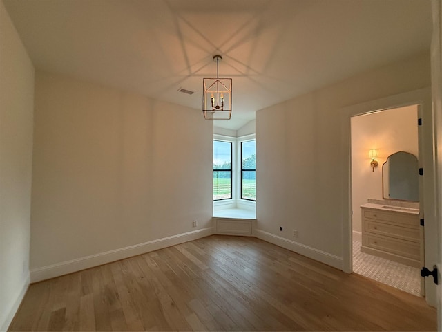 15420 Highlander Ct, Montgomery, TX 77356 - spare room featuring light wood finished floors, baseboards, and a chandelier