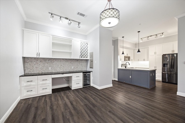 kitchen featuring fridge with ice dispenser, beverage cooler, visible vents, and track lighting