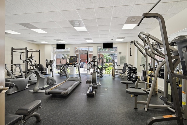 exercise room featuring a wealth of natural light and a paneled ceiling