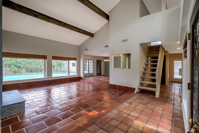 1319 E Brooklake Dr, Houston, TX 77077 - unfurnished living room featuring high vaulted ceiling, stairway, baseboards, beam ceiling, and visible vents