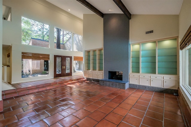 1319 E Brooklake Dr, Houston, TX 77077 - unfurnished living room with a towering ceiling, tile patterned floors, visible vents, a multi sided fireplace, and beam ceiling