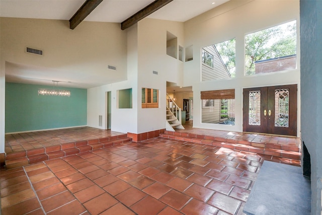 1319 E Brooklake Dr, Houston, TX 77077 - unfurnished living room with beam ceiling, visible vents, a towering ceiling, a notable chandelier, and tile patterned flooring