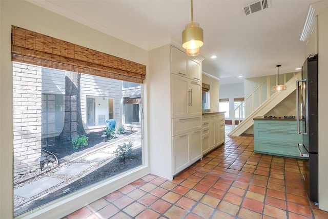 1319 E Brooklake Dr, Houston, TX 77077 - kitchen with recessed lighting, visible vents, freestanding refrigerator, crown molding, and white cabinetry