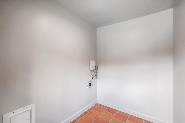 1319 E Brooklake Dr, Houston, TX 77077 - laundry room with baseboards, tile patterned flooring, and laundry area