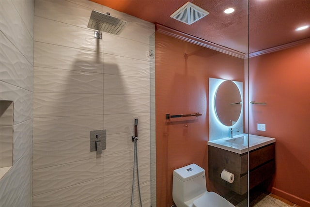 1319 E Brooklake Dr, Houston, TX 77077 - bathroom with vanity, toilet, ornamental molding, visible vents, and tiled shower