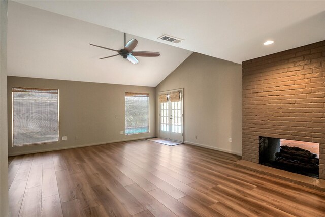 1319 E Brooklake Dr, Houston, TX 77077 - unfurnished living room with wood finished floors, a ceiling fan, a brick fireplace, and visible vents