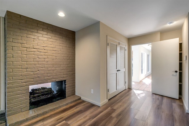 1319 E Brooklake Dr, Houston, TX 77077 - unfurnished living room featuring baseboards, wood finished floors, a fireplace, and recessed lighting