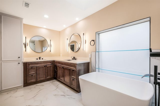 1319 E Brooklake Dr, Houston, TX 77077 - bathroom with a sink, a freestanding tub, marble finish floor, double vanity, and visible vents