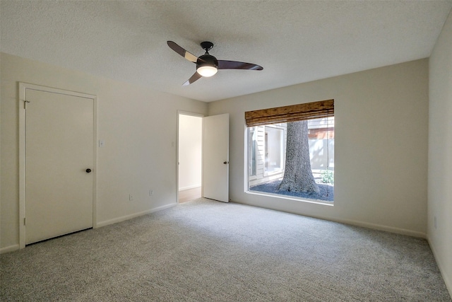 1319 E Brooklake Dr, Houston, TX 77077 - unfurnished bedroom featuring carpet, a textured ceiling, baseboards, and ceiling fan