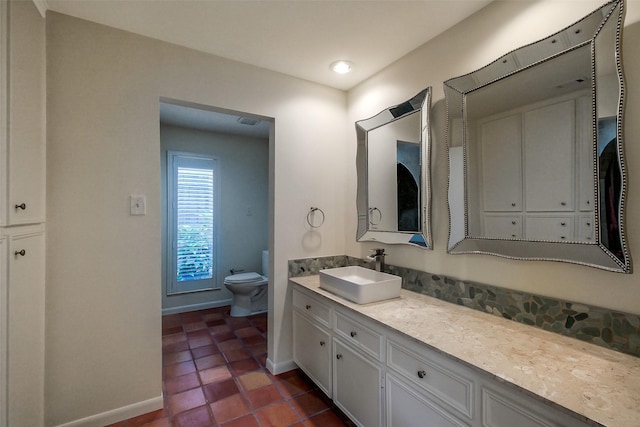 1319 E Brooklake Dr, Houston, TX 77077 - bathroom with baseboards, vanity, tile patterned floors, and toilet