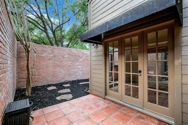 1319 E Brooklake Dr, Houston, TX 77077 - view of patio / terrace featuring fence and french doors