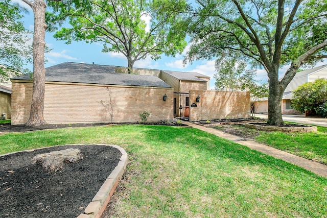1319 E Brooklake Dr, Houston, TX 77077 - view of front of house with brick siding and a front yard
