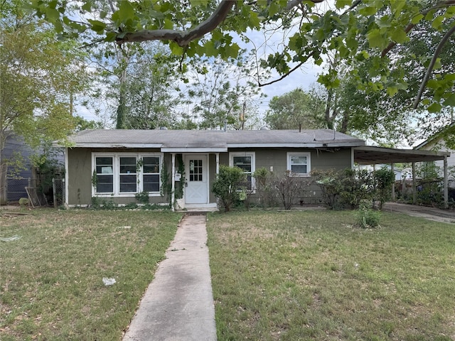 ranch-style house with an attached carport, fence, and a front yard