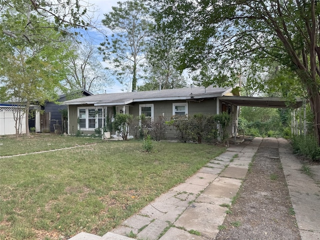 single story home with driveway, a front yard, a carport, and fence