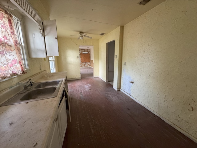 kitchen with white cabinets, dark wood-style floors, a sink, and a healthy amount of sunlight