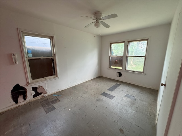 empty room featuring baseboards and a ceiling fan