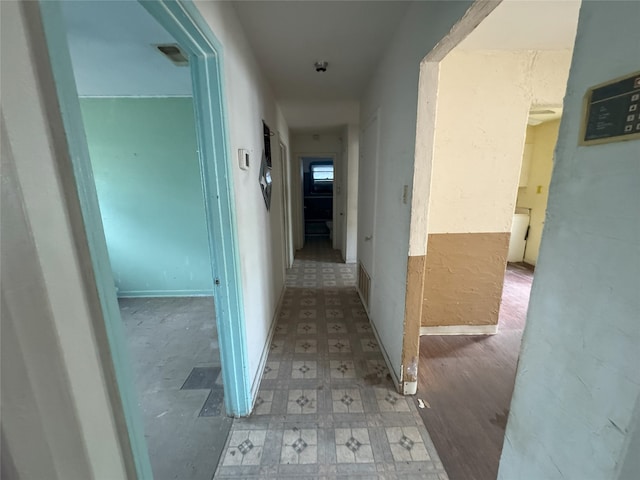 hallway with visible vents and light floors