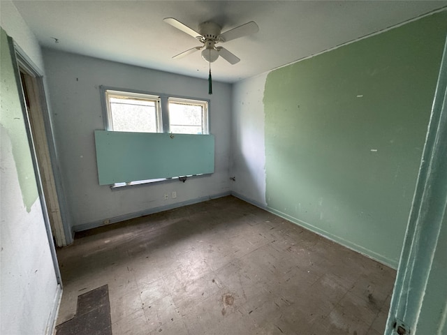 unfurnished bedroom with ceiling fan, baseboards, and tile patterned floors