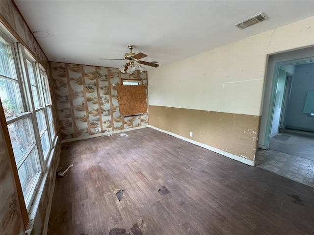 spare room with ceiling fan, baseboards, wood finished floors, and visible vents