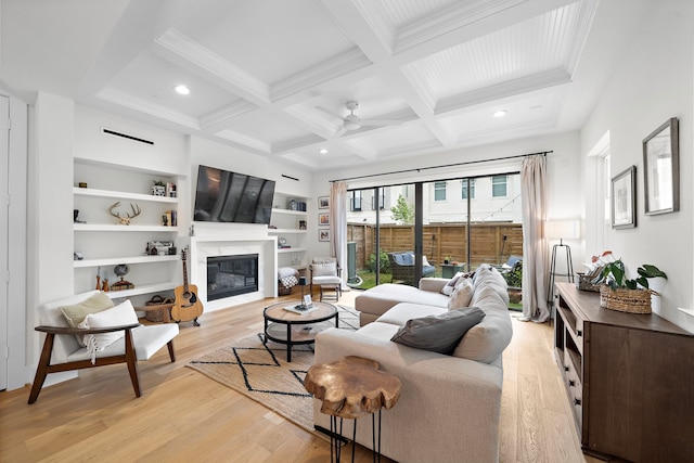 805 Fisher St Unit B, Houston, TX 77018 - living room with beamed ceiling, light wood finished floors, a ceiling fan, a high end fireplace, and coffered ceiling