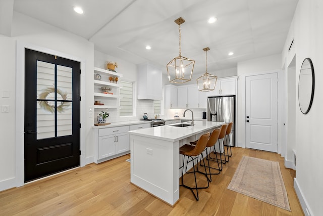 805 Fisher St Unit B, Houston, TX 77018 - kitchen featuring a sink, stainless steel appliances, white cabinetry, a breakfast bar area, and premium range hood