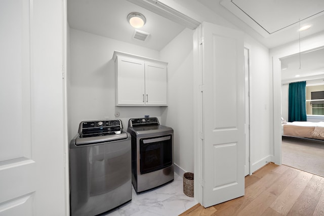 805 Fisher St Unit B, Houston, TX 77018 - washroom featuring attic access, cabinet space, and separate washer and dryer