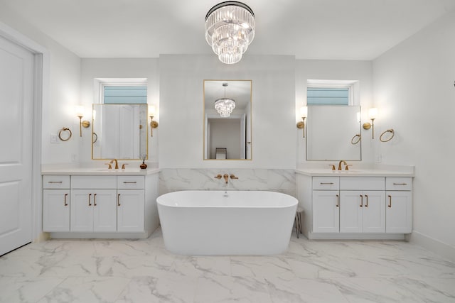 805 Fisher St Unit B, Houston, TX 77018 - bathroom with a chandelier, marble look tiles, two vanities, and a freestanding tub