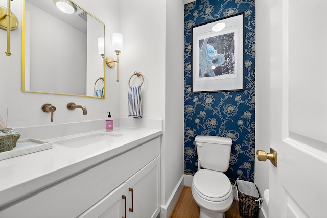 805 Fisher St Unit B, Houston, TX 77018 - half bathroom featuring wallpapered walls, vanity, toilet, baseboards, and wood finished floors