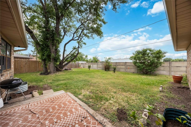view of yard with a patio area and a fenced backyard