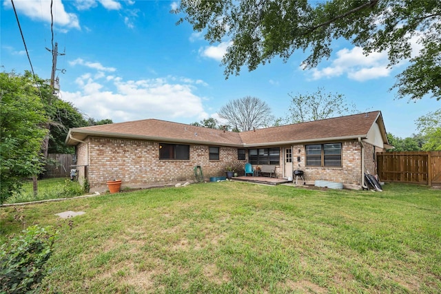 back of house with a patio area, fence private yard, brick siding, and a yard