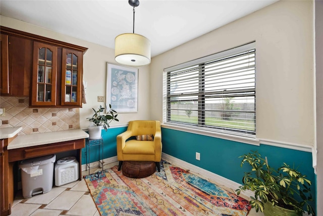 living area featuring light tile patterned flooring and baseboards