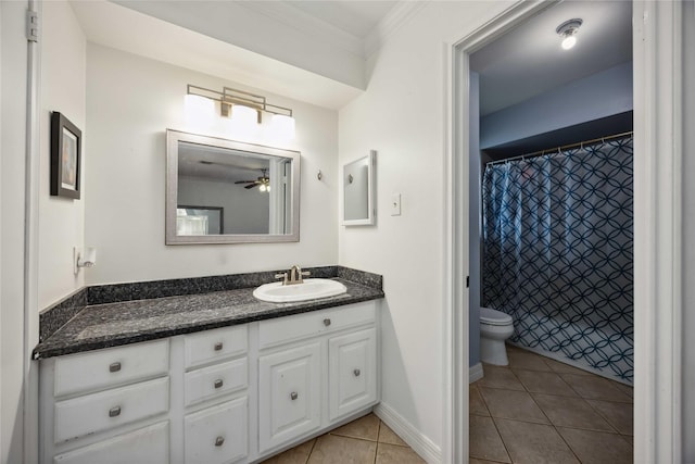 bathroom featuring tile patterned floors, toilet, vanity, crown molding, and ceiling fan