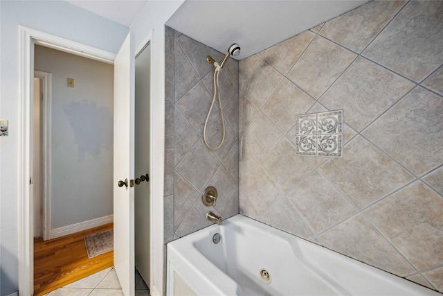 bathroom with baseboards and shower / bathtub combination