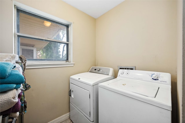 laundry area with baseboards, washer and clothes dryer, and laundry area