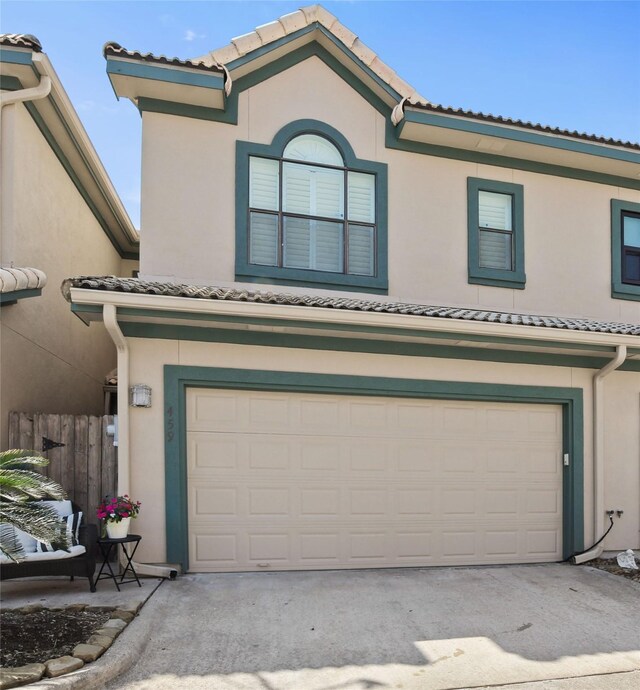 459 Mariners Dr, Kemah, TX 77565 - multi unit property featuring an attached garage, stucco siding, a tiled roof, and fence