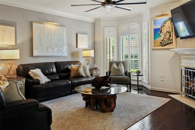 459 Mariners Dr, Kemah, TX 77565 - living room with ceiling fan, crown molding, wood finished floors, baseboards, and a fireplace