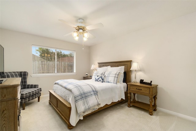 2104 Olympic Dr, League City, TX 77573 - bedroom featuring light carpet, a ceiling fan, and baseboards