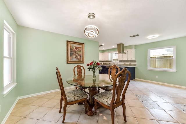 dining area with light tile patterned flooring, visible vents, baseboards, and a notable chandelier