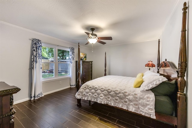 bedroom featuring dark wood finished floors, baseboards, ornamental molding, and ceiling fan
